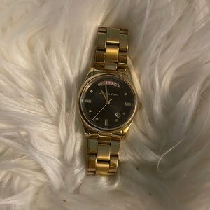 Michael Kors Women’s gold watch with date and day